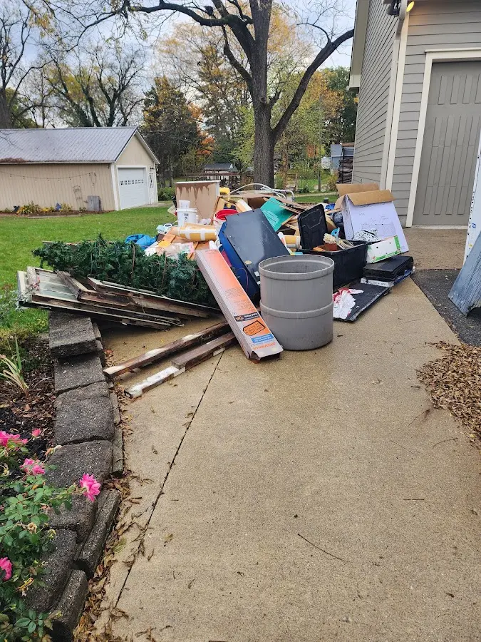Dumpster being loaded with debris for Estate Cleanout Dumpster Rental in Lead